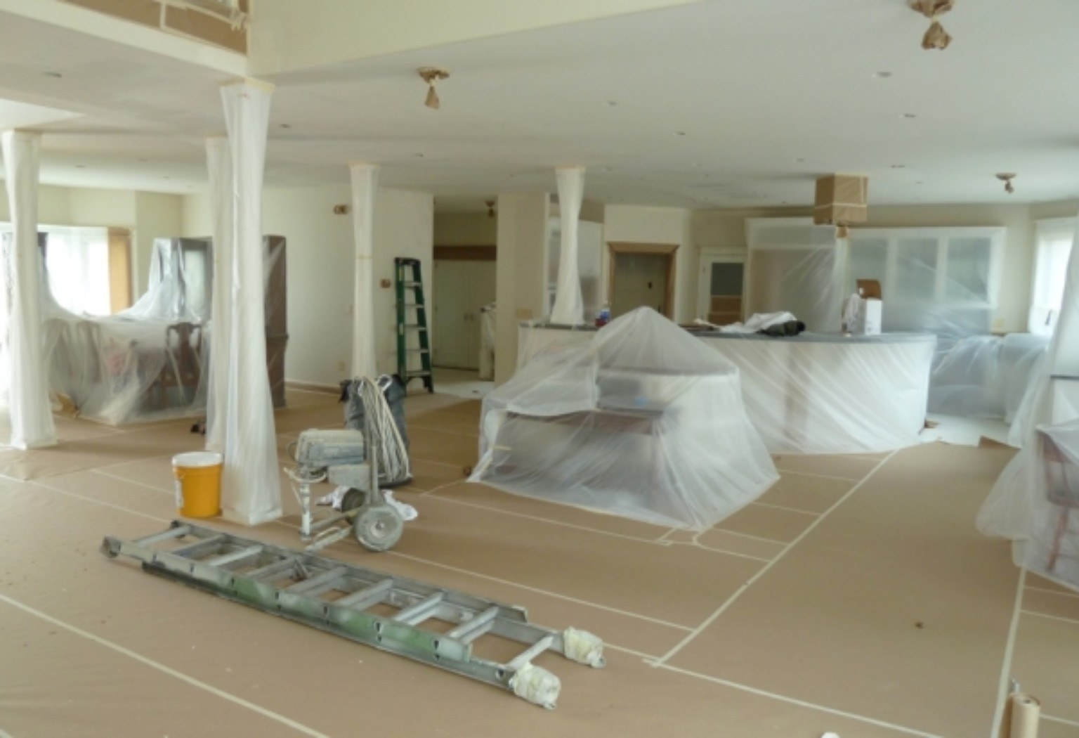 Interior painting project with floors and furniture carefully masked and protected